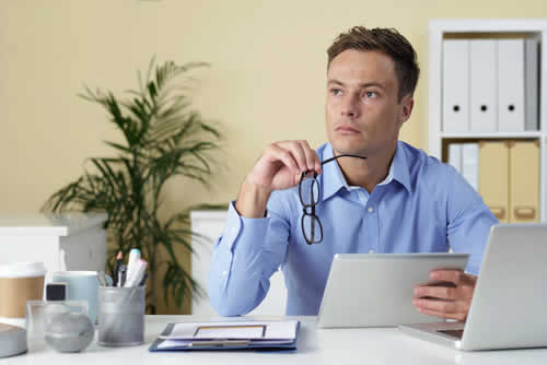 Business owner thinking about unpaid invoices