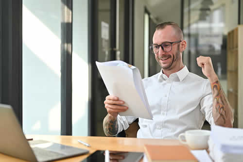 Happy entrepreneur with profit and loss statement