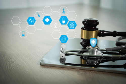 Gavel and stethoscope on desk