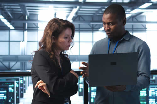 IT manager teaching team member about security risks