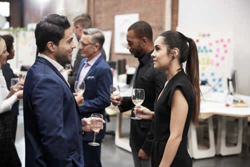 Attendees speaking at networking event