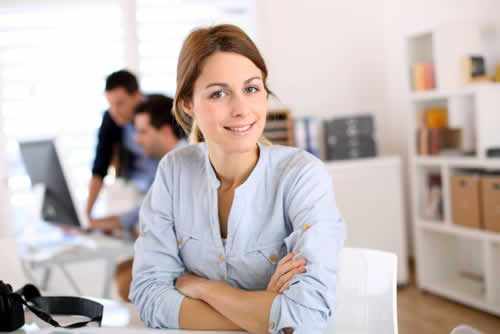 Happy confident relaxed person at work looking at the camera