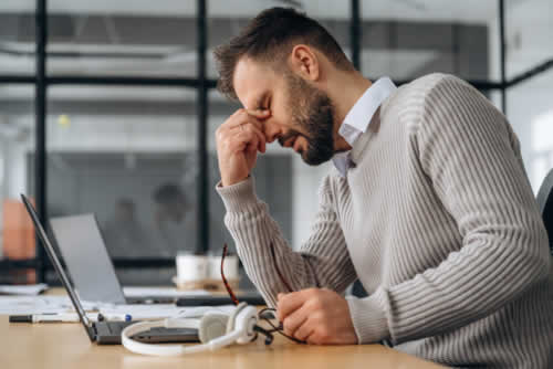 Stressed person at work feeling bad
