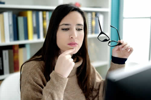Student looking doubfully at a computer screen
