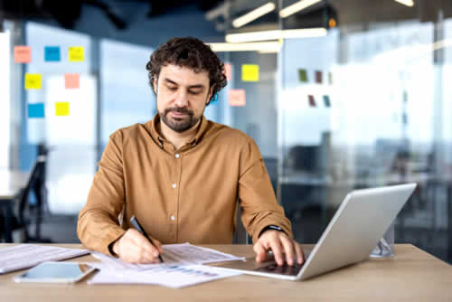 Manager looking at reports on their LMS