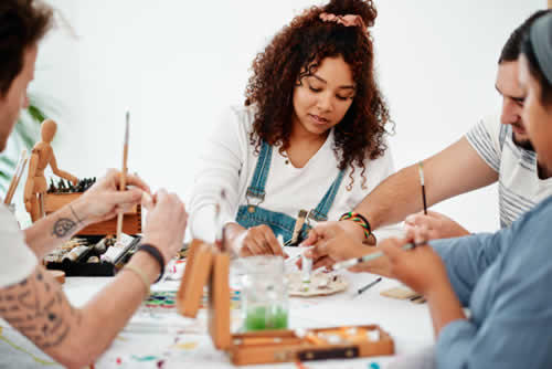 People working together in a painting class