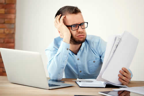 Bored manager looking at report