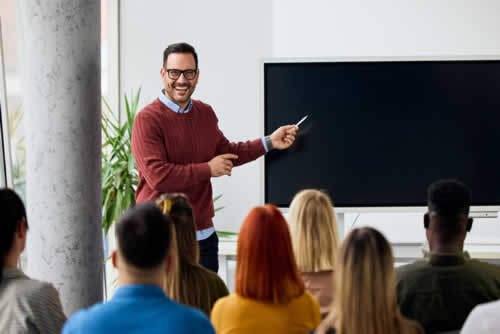 Happy trainer delivering a class to the office team