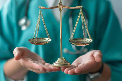 Nurse holding a set of scales