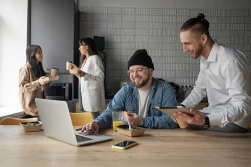 Office team members talking and sharing