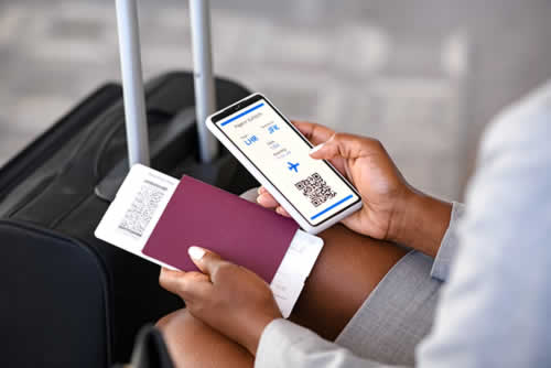 Businesswoman using mobile travel app