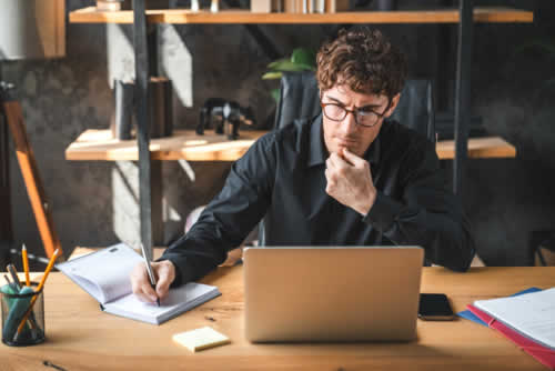 Serious office worker busy at desk