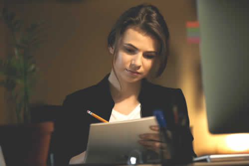 IT manager checking off a list of jobs