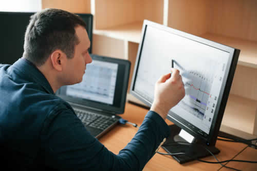 IT technician reading a report on system uptime
