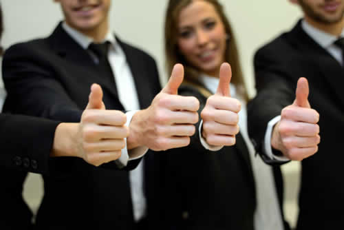 Training delegates giving approval with thumbs up