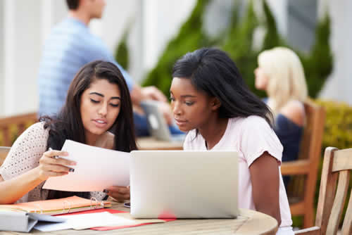 Students reading their assignment copy