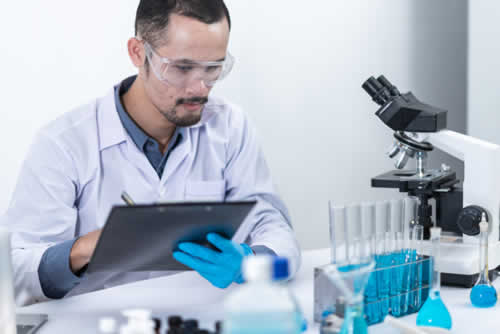 Technician updating a register of equipment